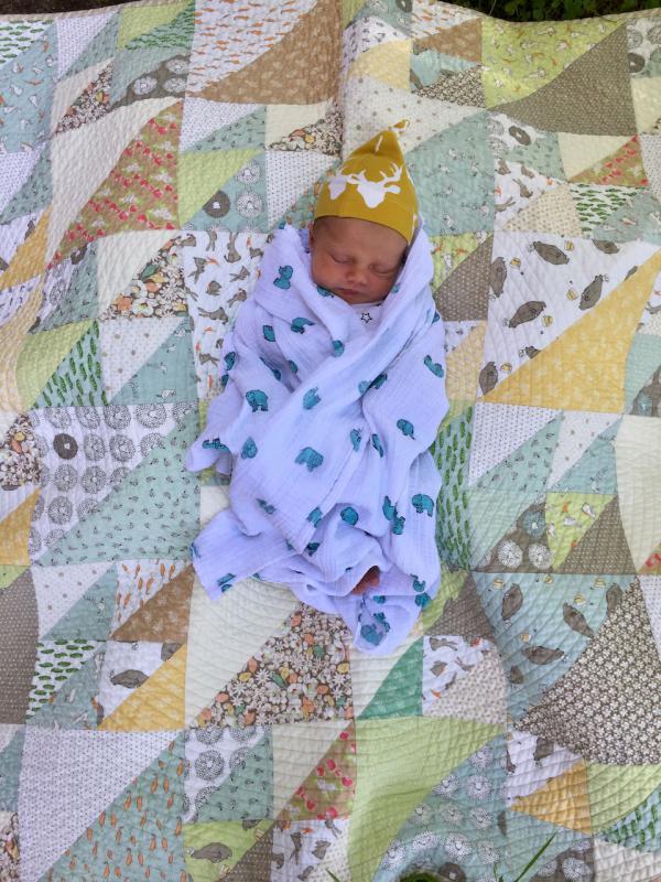 lkm_Linzee McCray grandmother baby Freya on quilt