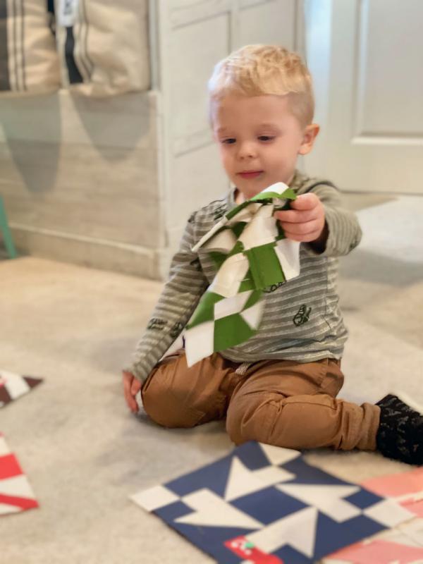 Lissa Alexander's grandson sorting quilt blocks