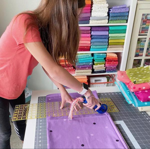 Katie Christenson cutting fabric with her mom Vanessa